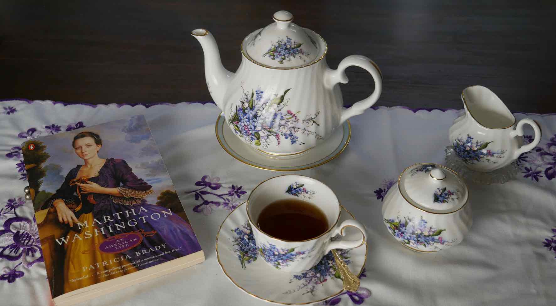 book Martha Washington by Patricia Brady with Anne's tea service on table runner hand-embroidered in Hungary