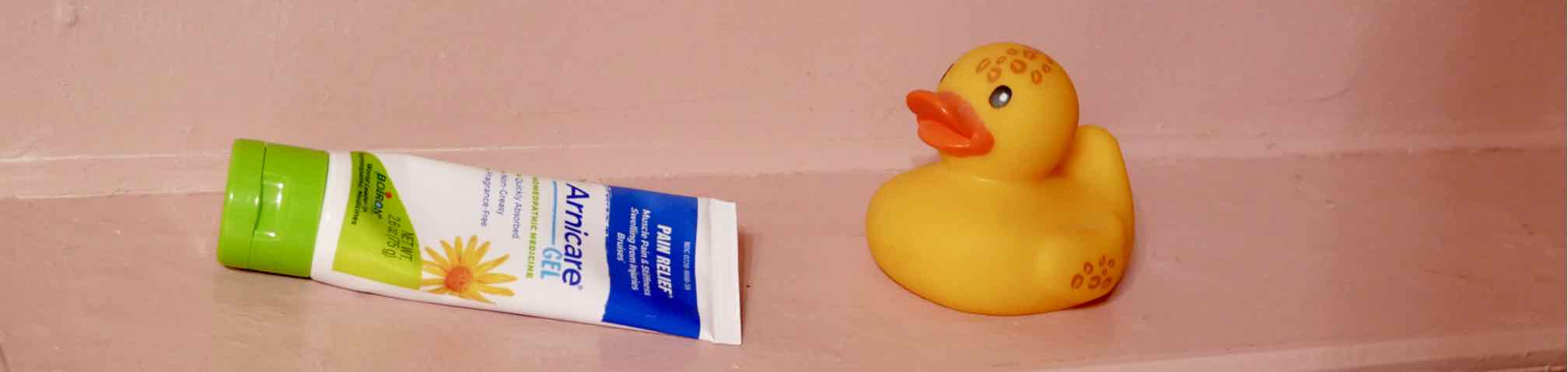 tube of Arnicare Gel and a rubber ducky