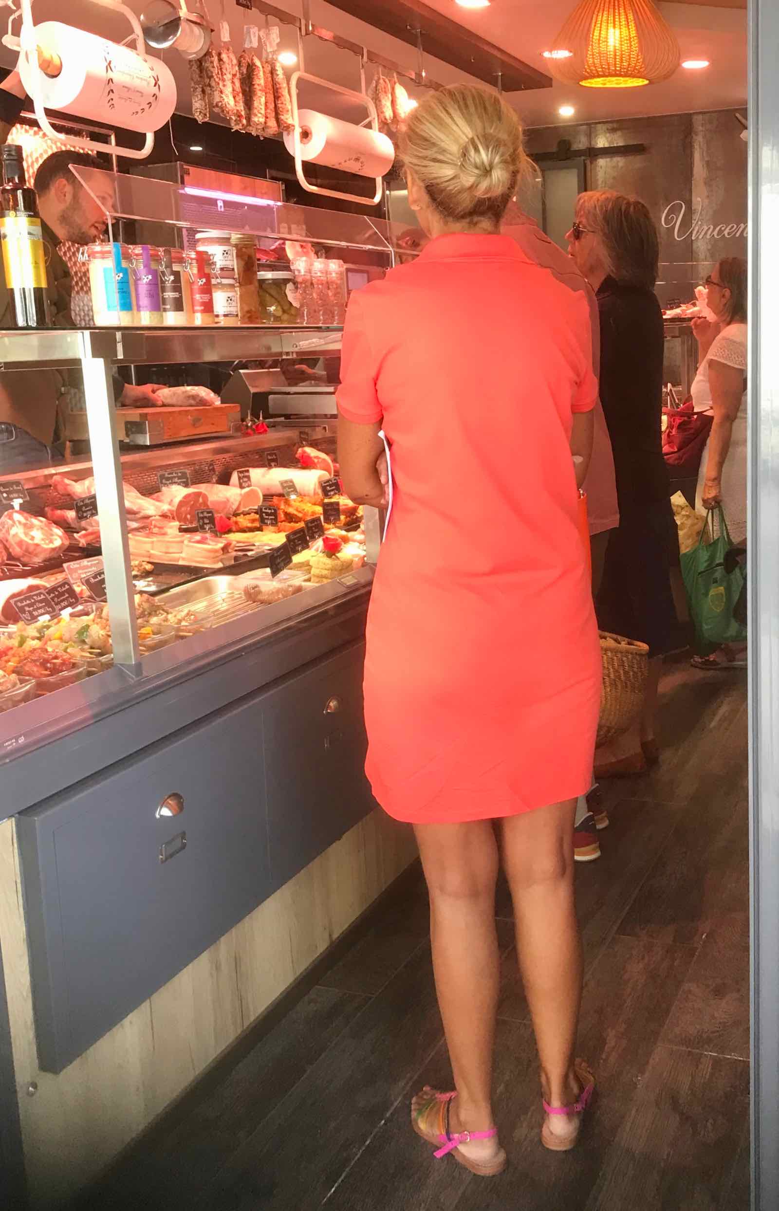 Woman in coral/pink dress and pink sandals