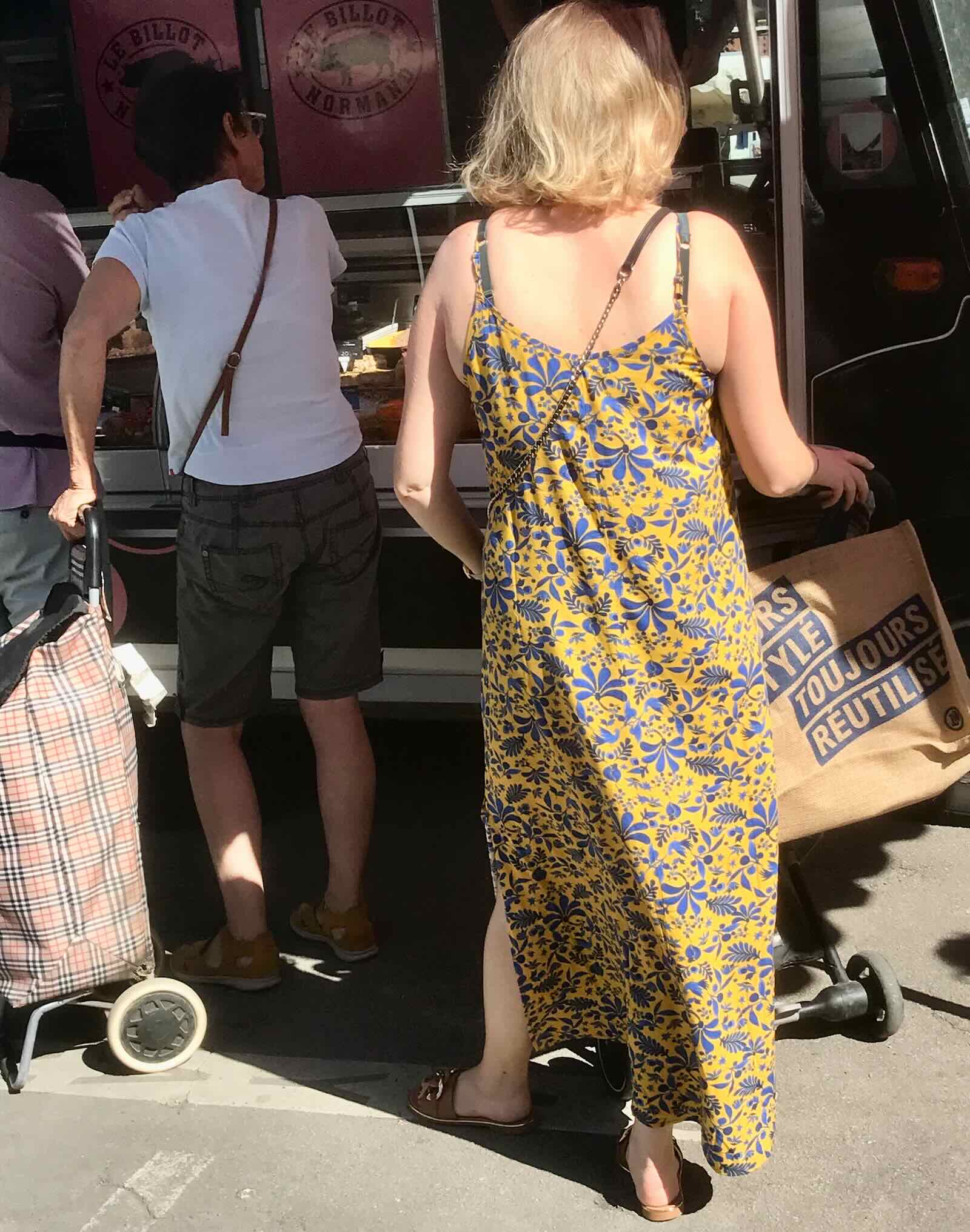 two women shopping in French market in summer